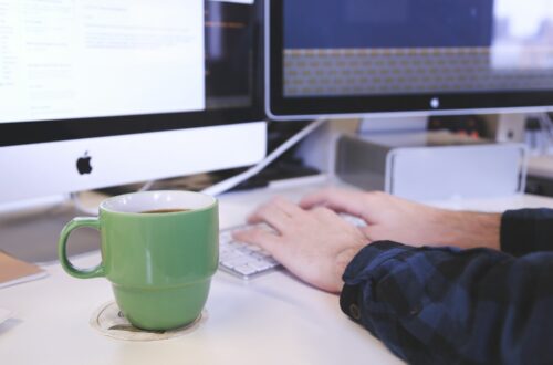 Person Typing On Keyboard With Coffee Free Stock Picture